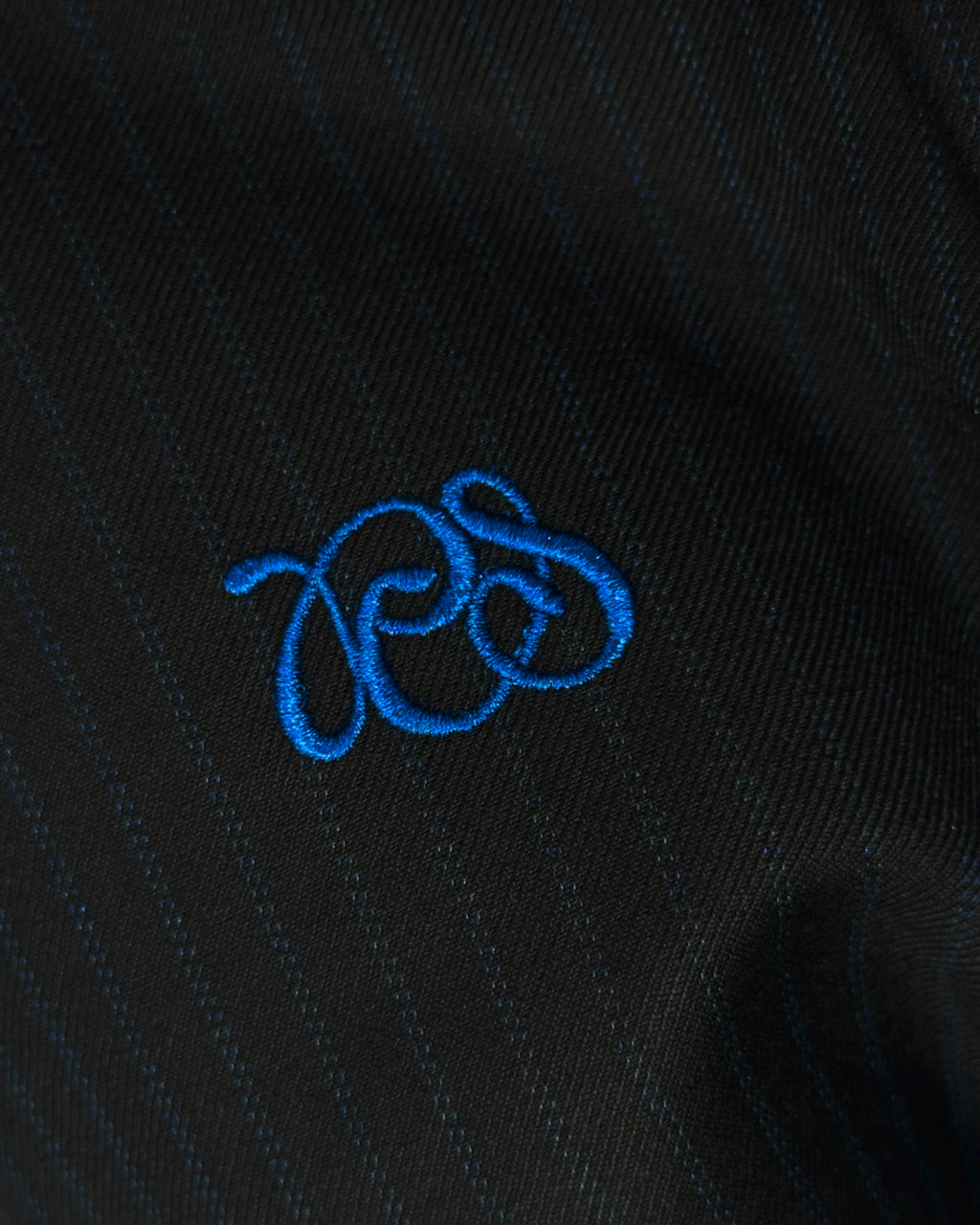 PCES lettering logo in Blue embroidered on black and blue striped wool blended fabric  